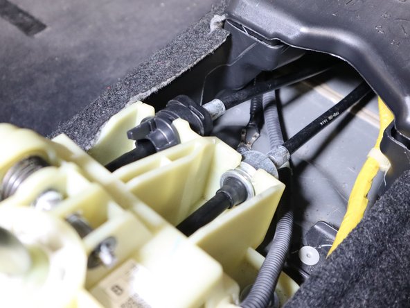 On the left side of the shifter, remove the pin that holds the left hand shifter cable in place. Slide it off the pin.