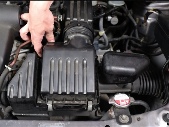 Unclip the four clips holding the airbox lid in place.