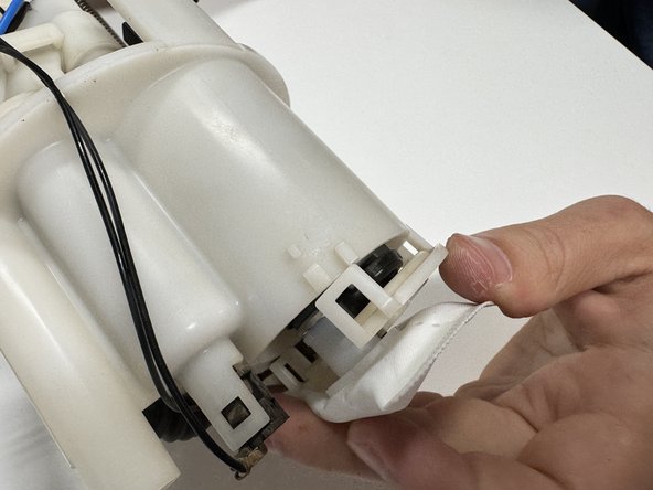 Push the lower pump cover onto the housing. This should snap back in place just like it was when you removed it. Make sure all tabs are clipped in otherwise the fuel pressure can push the pump out when it is turned on.