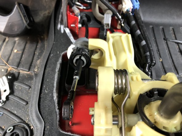 Rotate the cable lock all the way and slide it out of the shifter assembly.