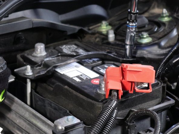 Unbolt and remove the battery tie-down bracket.