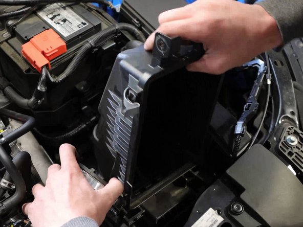 Grab the bottom airbox and pull upwards, the lower section is held in place by a grommet.