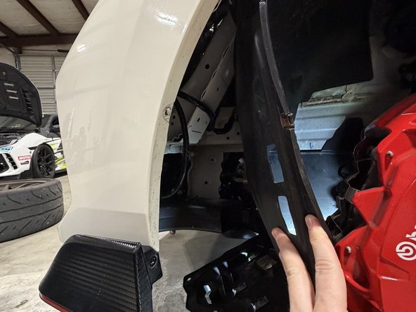 Pull back the inner fender and locate the position for the lower air inlet.