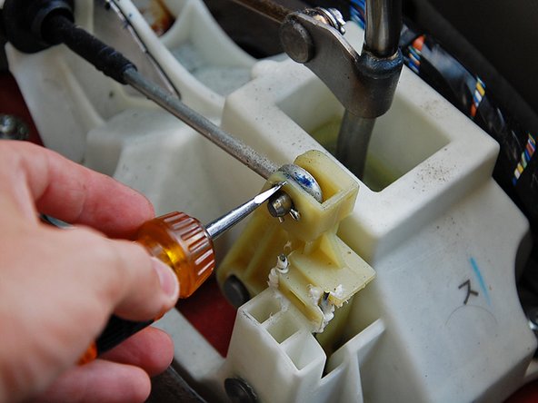 Use a small flat head screwdriver and bend the cotter pins straight, remove both cotter pins securing the cable end links to the shifter and pull them off the shifter.