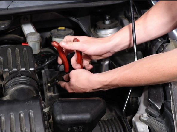Remove the wire harness clip that is attached to the battery tray.