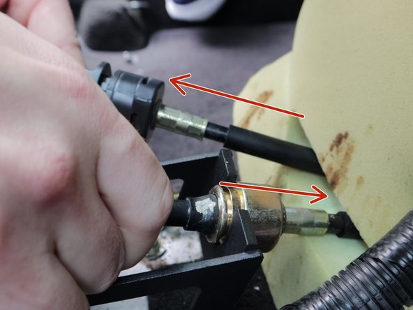 Reinstall the shifter cables. You will need to push the RH side cable through the grommnent in the floor slightly. This can be tough so you may need to use some lubricant to get it to slide. You will slide it forward through the floor just enough so the cable can attach to the shifter. The LH cable may need to be pulled through the floor slightly.