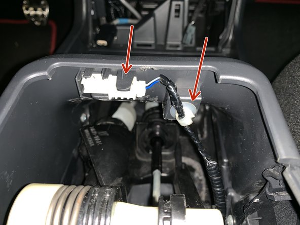 You will need to lift the console up and unplug it from the bottom.