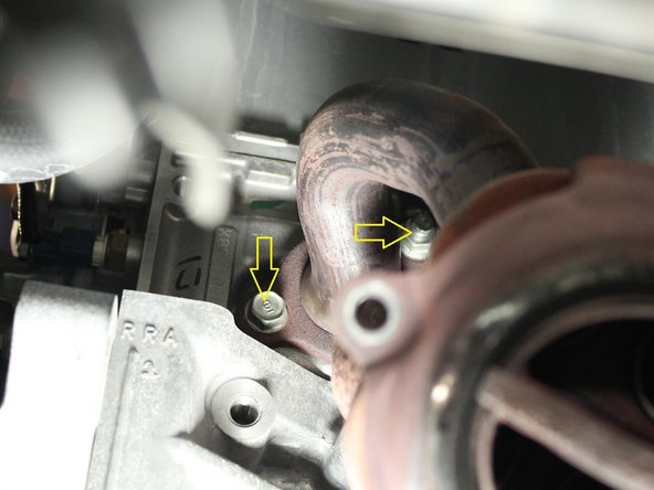 The exhaust manifold will rest on the upper studs once the all of the bolts/ nuts have been removed.