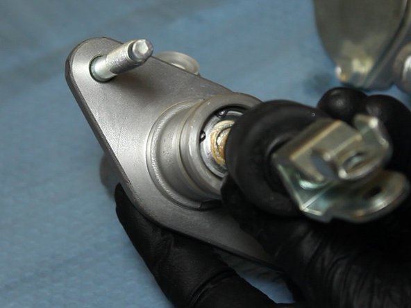 Using the C-clip pliers, remove the rod and for from the EM1 CMC.