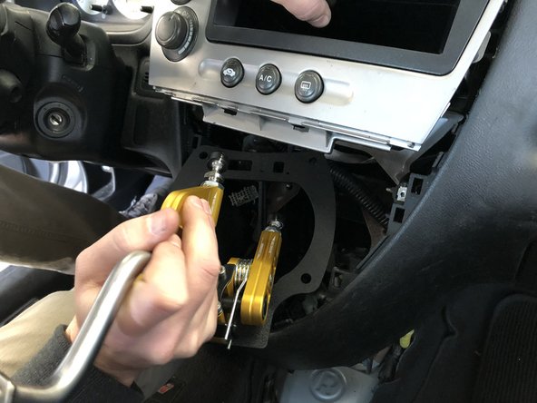 Insert your new Hybrid Racing shifter into the dash by holding the dash center out of the way. This shifter is much smaller so it should slide in easy.