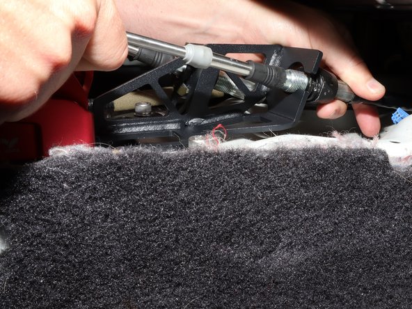 Insert the RH side shifter cable into the shifter and slide the end link onto the shifter arm.