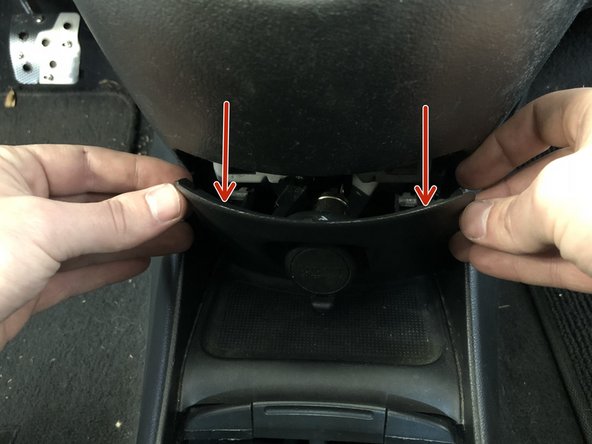 Use a trim removal tool to pop the center console cover off to expose the accessory outlet connector.