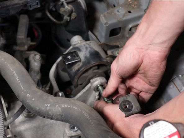 Be sure the transmission is fully supported before removing this bolt.