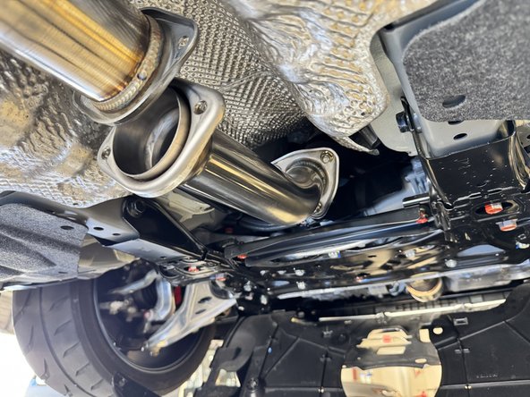 With both gaskets installed on the front pipe adapter, install it on the car. Be sure to keep the bolts loose for the time being.