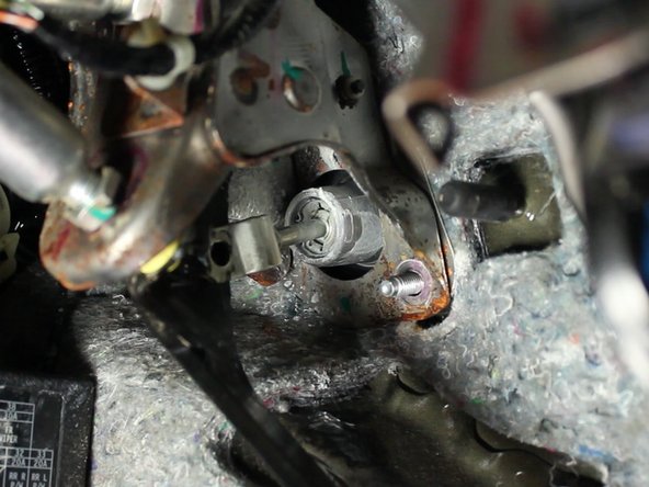 Using a 12mm socket, remove the two mounting nuts that hold the clutch master cylinder in place.