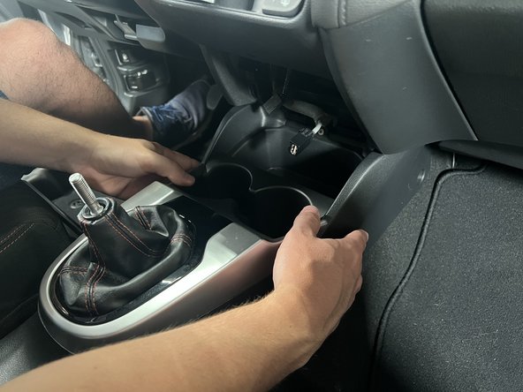 Slide it backward and lift the rear section upward.