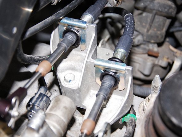 Once you have the cables staying there we can now move back under the hood.