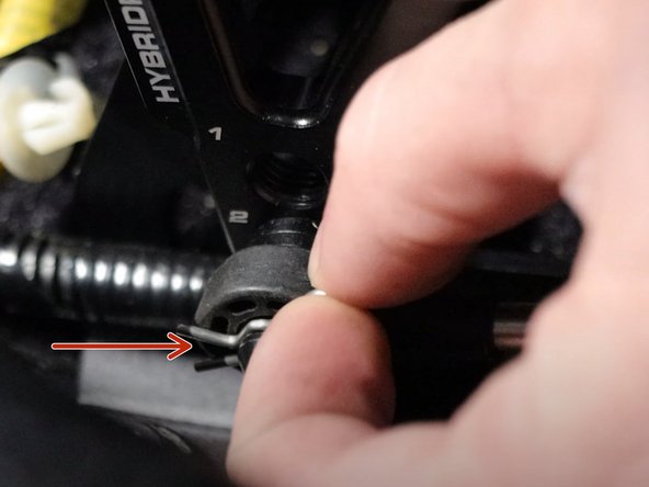 Remove the cotter pin from the right side shifter cable and slide it off the shifter pin. This cable should be completely free of the shifter.