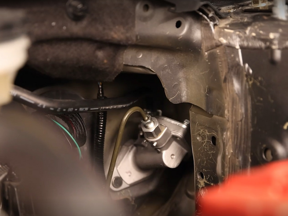 Use a hardline wrench and unbolt the clutch line from the CMC.