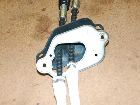 First we will need to remove the two mounting brackets off of the OEM cables(keep the larger bracket on the right handy as we will need it in the install later-Fig 1) so we can slide the mounting plate off.