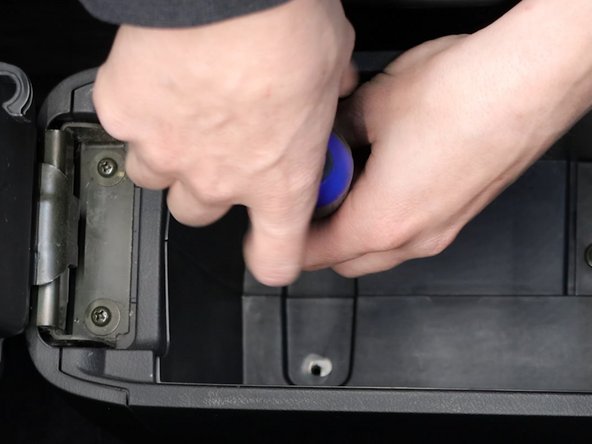 Remove the Phillips screws inside of the arm rest base.