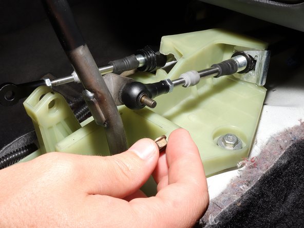 Remove the RH side shifter cable from the shift rod. You may need to use a 10mm socket.