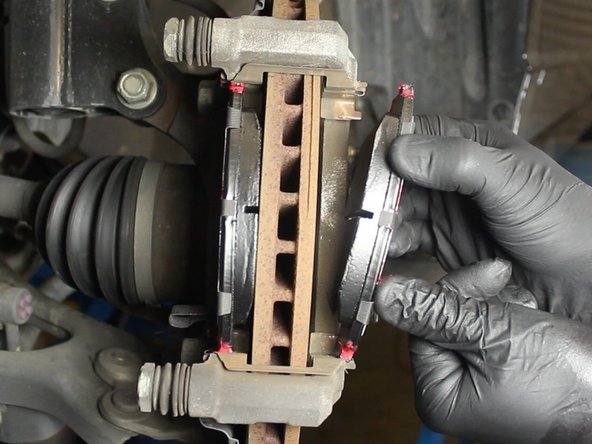 Make sure the brake pad with the wear indicator is on the inside.