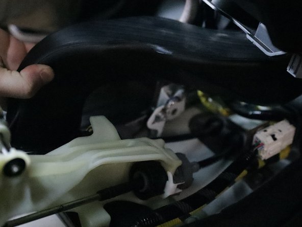 Unbolt the front lower bracket and remove the plastic AC duct.