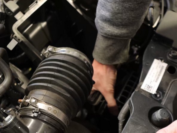 Grab the bottom airbox and pull upwards, the lower section is held in place by a grommet.