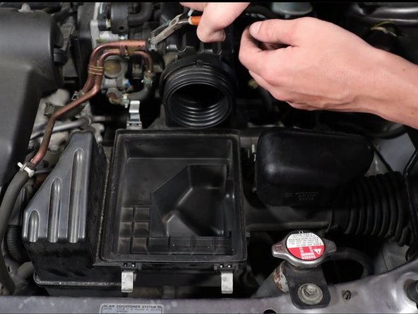 Remove the airbox vacuum line.