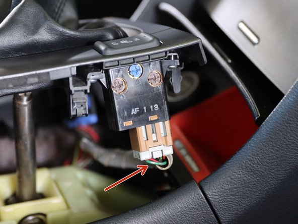 Locate both seat heater connectors and unplug them.