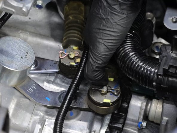 Remove the shifter cable retaining clips.