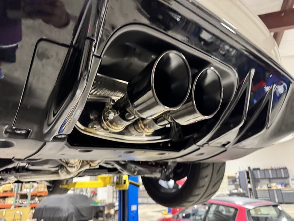 Once the hangers and pipes are tight, install the exhaust tips and align the clamps.
