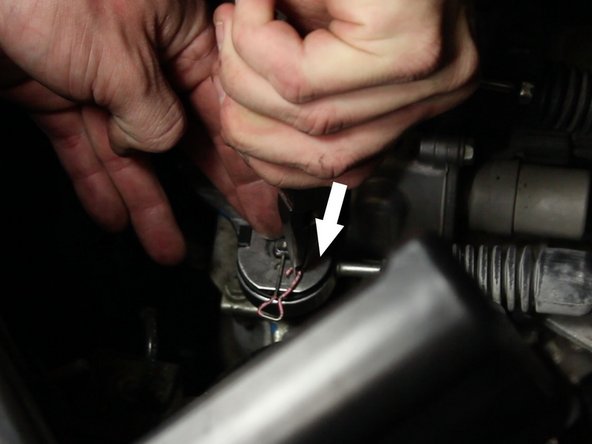 With a pair of needle nose pliers, remove the cotter pin from the top of the large cable bushing.