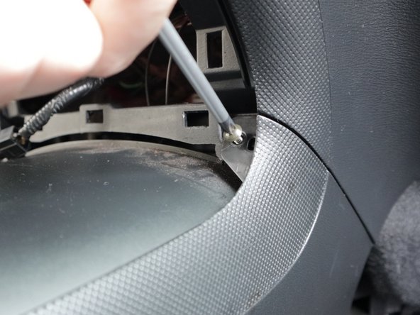 Remove the two Phillips screws on the sides of the rear section of the console. There is one on each side.