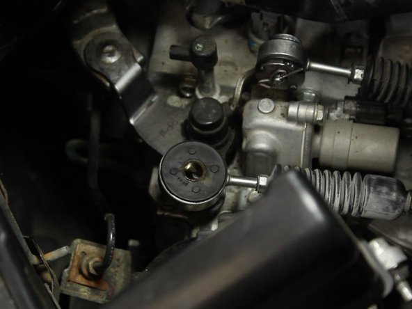 Pry the remaining rubber bushing out of the cable end.