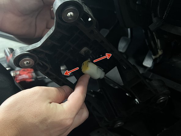 Rotate the shifter and remove the RH side shifter cable.