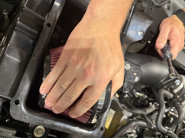 Slide the cone filter onto the velocity stack inside the airbox.