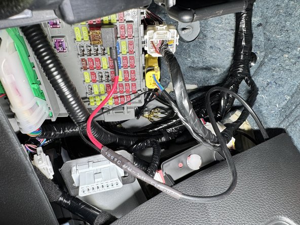 There is a ground junction on the chassis behind the fuse box, loosen the bolt and install the ground lead from the EVC harness.