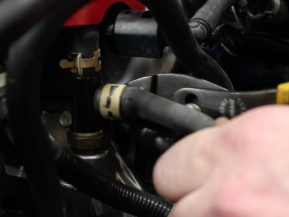 Use plies to remove the hose clamp and then remove the factory hose.