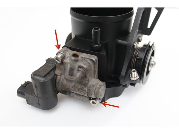 Place the OE IACV gasket into the machined groove on the bottom side of the throttle body. Next, place the IACV on the gasket aligning the two mounting holes.