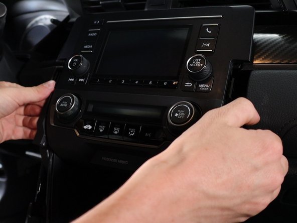 Use your fingers and gently pry the HVAC control panel outward. This will unclip and then you can unplug it.