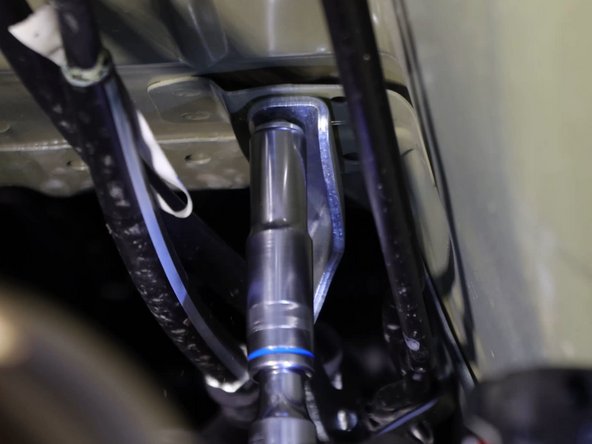 Remove the nuts holding the shifter cable bracket to the frame.