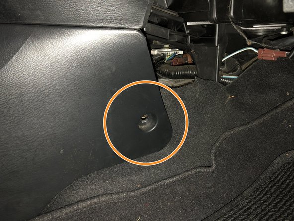 Remove the two screws holding the front section of the console in place.