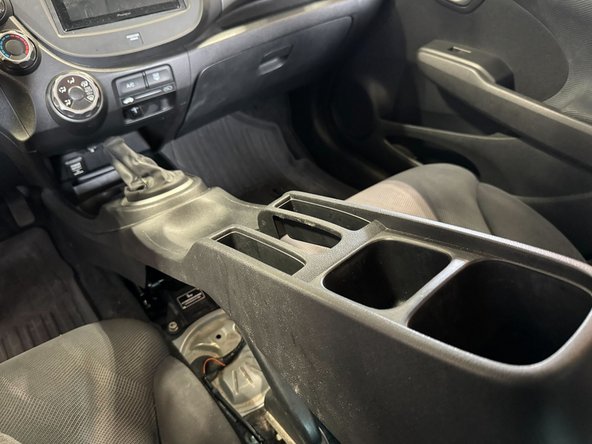 With rear of center console raised, push console into place in foot wells.