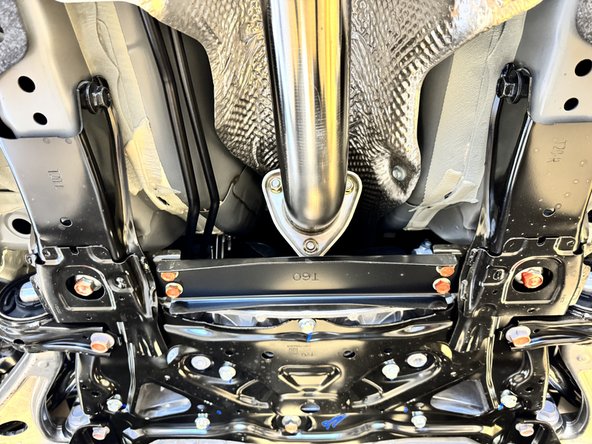 With both gaskets installed on the front pipe adapter, install it on the car. Be sure to keep the bolts loose for the time being.