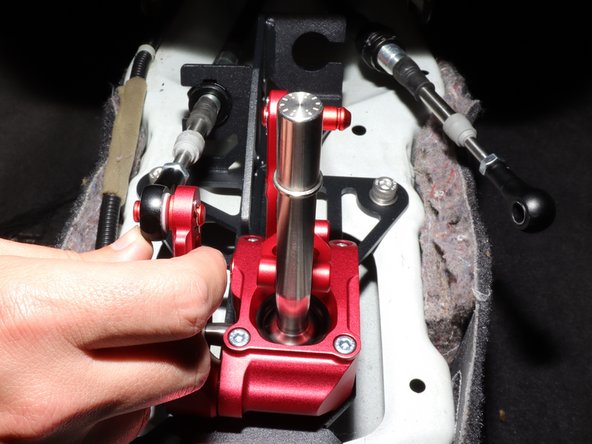 Install the LH side cable by inserting it into the shifter, and slide the end link onto the shifter.