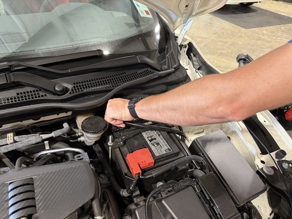 Always disconnect the negative terminal first. The negative cable has the battery sensor built in. Loosen the nut and lift by the terminal, not by the sensor or its connector.
