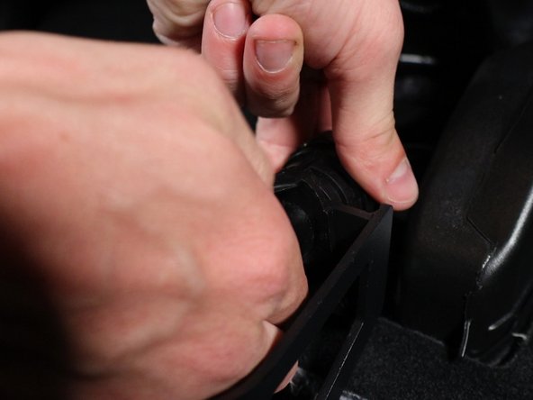 Spread the wire apart and slide the cable off the ball.