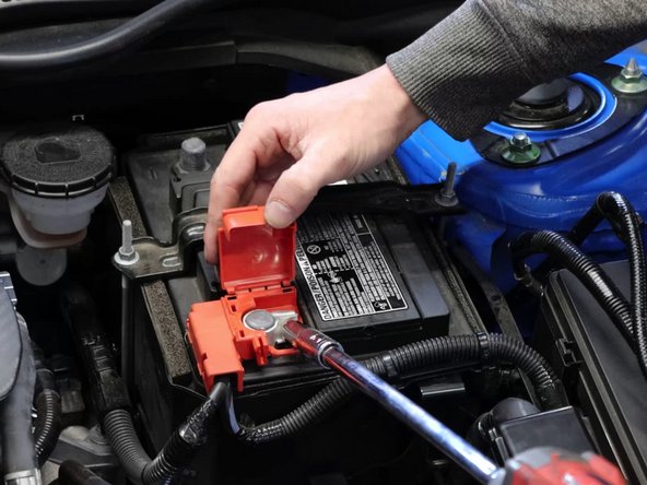 Remove the negative then positive terminal from the battery.